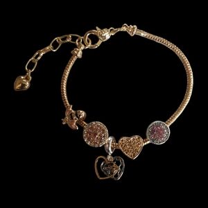 Gold tone bracelet with multicolor charms